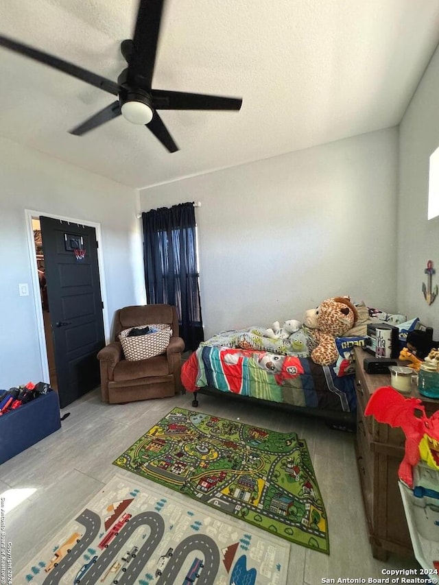 bedroom with ceiling fan and light hardwood / wood-style flooring