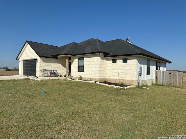 view of side of property with a garage and a lawn