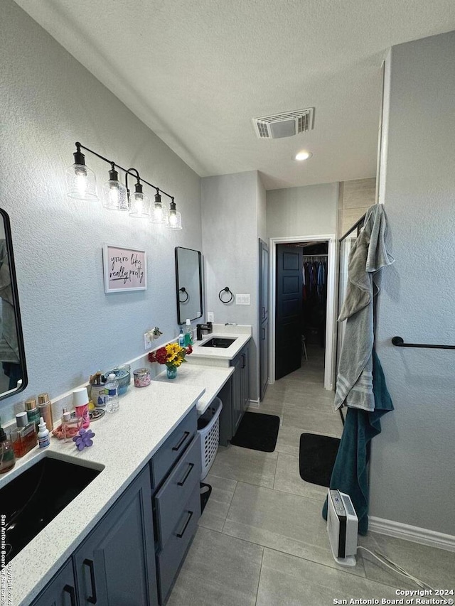 bathroom featuring vanity, a textured ceiling, and tile patterned floors