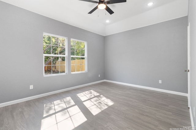 unfurnished room with ceiling fan and hardwood / wood-style flooring