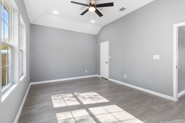 empty room with vaulted ceiling, hardwood / wood-style floors, and ceiling fan