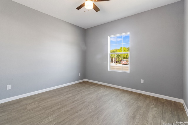 unfurnished room with hardwood / wood-style flooring and ceiling fan