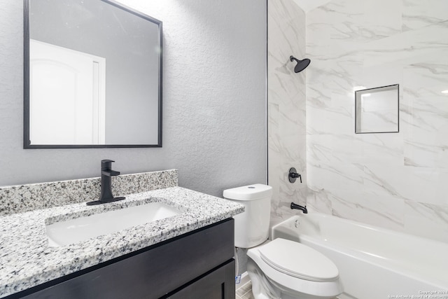 full bathroom featuring tiled shower / bath combo, vanity, and toilet