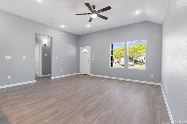 unfurnished living room featuring ceiling fan, hardwood / wood-style flooring, and vaulted ceiling