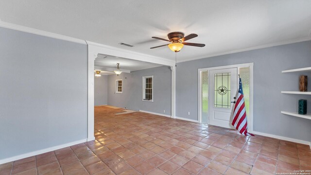 spare room with ceiling fan, baseboards, and ornamental molding