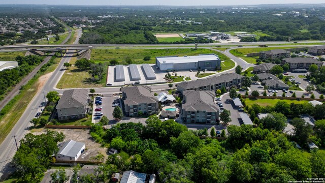 aerial view of property and surrounding area featuring nearby suburban area