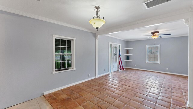 tiled spare room featuring ornamental molding, a ceiling fan, and baseboards