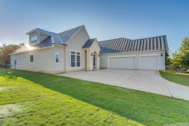 view of front of house featuring a garage and a front lawn