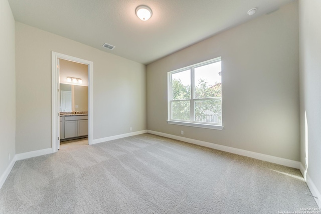 24706 Faraday, San Antonio, TX 78257 - unfurnished bedroom with connected bathroom, light colored carpet, baseboards, and visible vents