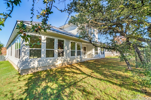 24706 Faraday, San Antonio, TX 78257 - view of side of property with a yard, a standing seam roof, metal roof, and central air condition unit