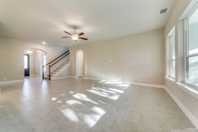 empty room featuring ceiling fan and light tile patterned flooring