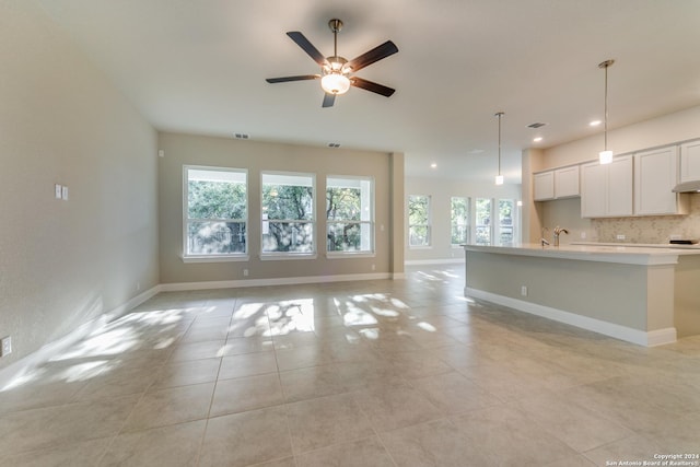 24706 Faraday, San Antonio, TX 78257 - unfurnished living room featuring a ceiling fan, a sink, baseboards, recessed lighting, and light tile patterned flooring