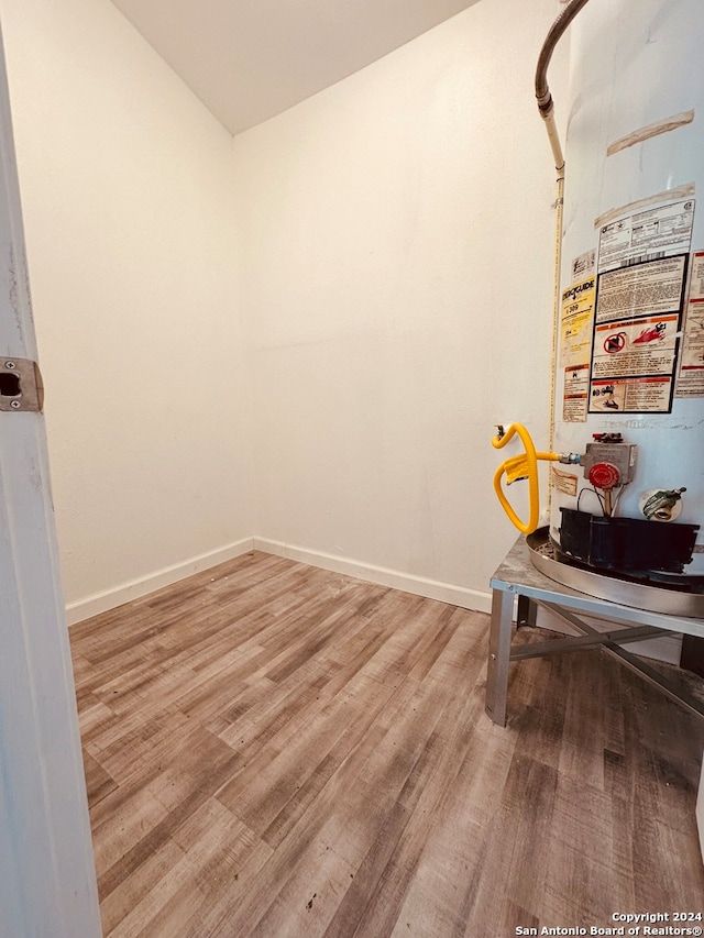 office space with gas water heater and wood-type flooring