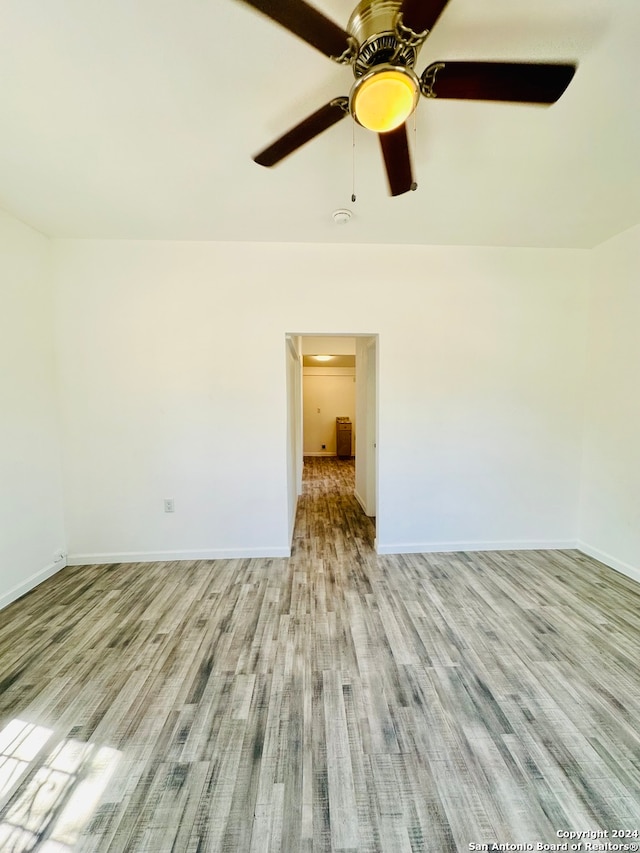 unfurnished room with ceiling fan and light hardwood / wood-style floors