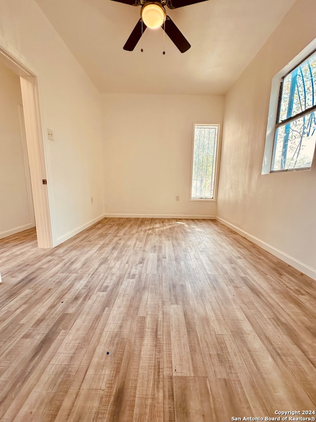 empty room with light hardwood / wood-style floors and ceiling fan