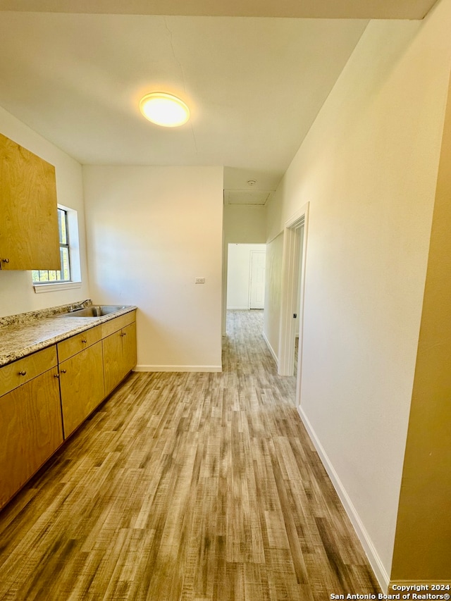 kitchen with light hardwood / wood-style flooring and sink