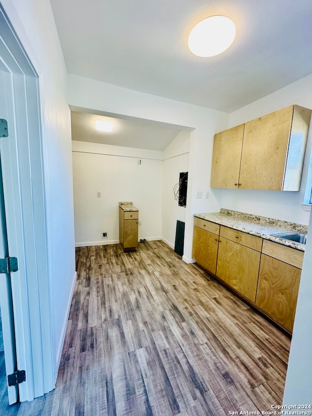 kitchen featuring light wood-type flooring and sink