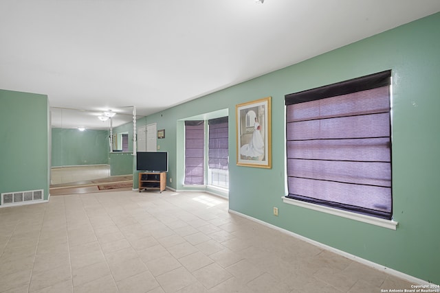 unfurnished living room with light tile patterned floors