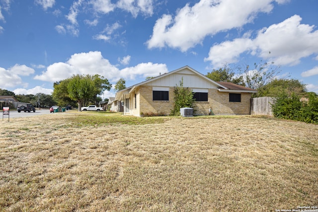 exterior space with a yard and cooling unit