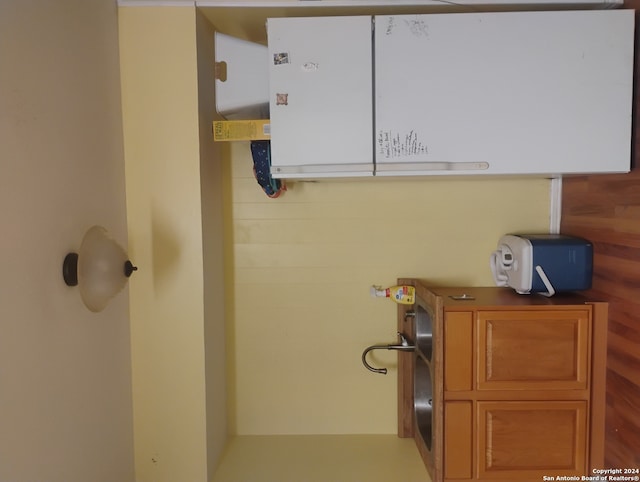 clothes washing area with wood walls