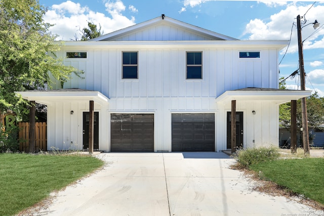 modern inspired farmhouse featuring a front yard and a garage