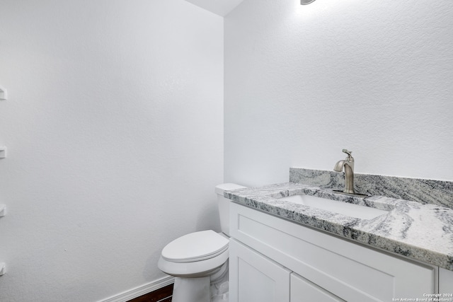 bathroom featuring toilet and vanity