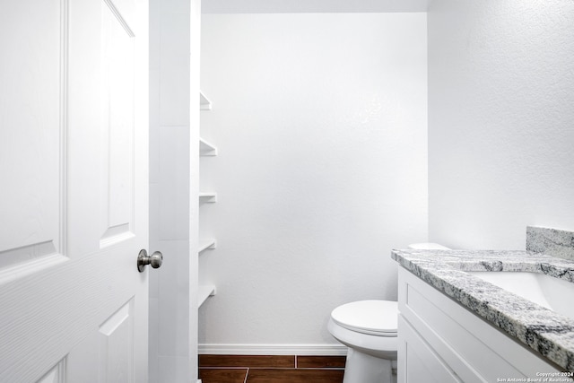 bathroom with tile patterned flooring, vanity, and toilet