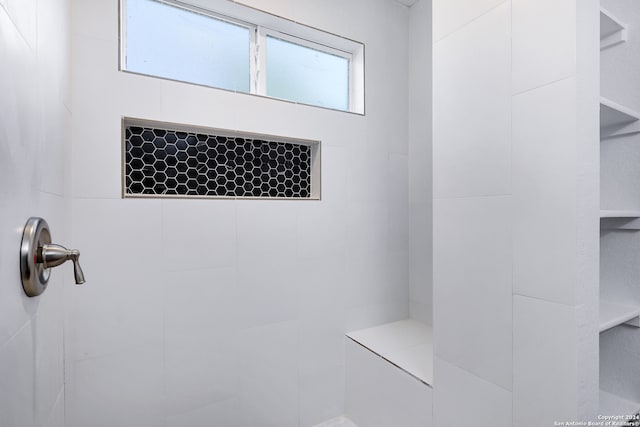 bathroom featuring plenty of natural light and a tile shower