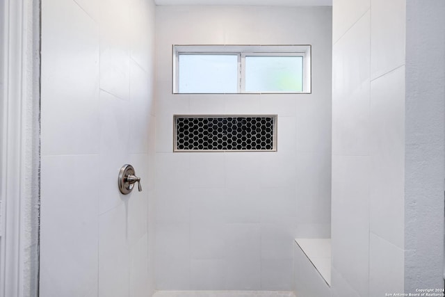 full bath featuring tiled shower