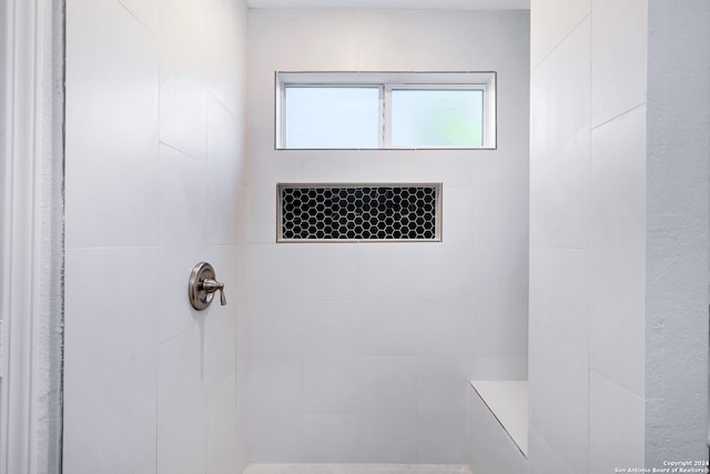 bathroom with a tile shower