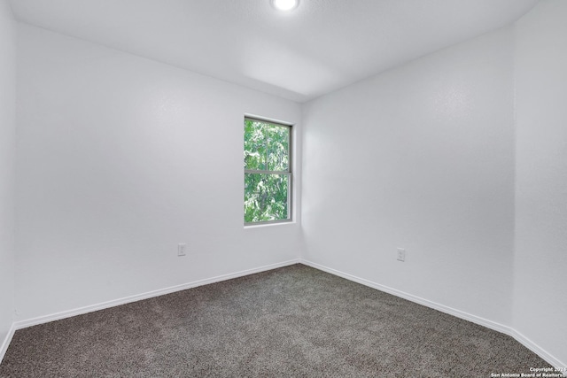 unfurnished room featuring recessed lighting, dark carpet, and baseboards