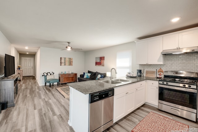 kitchen featuring appliances with stainless steel finishes, kitchen peninsula, and white cabinets