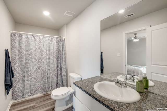 bathroom with ceiling fan, toilet, wood-type flooring, curtained shower, and vanity