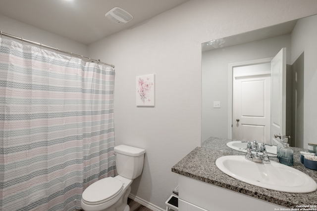 bathroom featuring walk in shower, vanity, and toilet