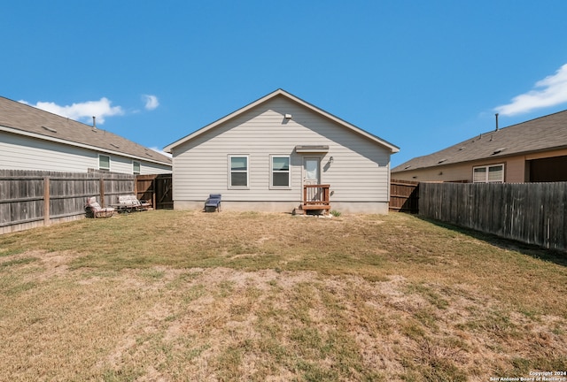 rear view of house with a yard