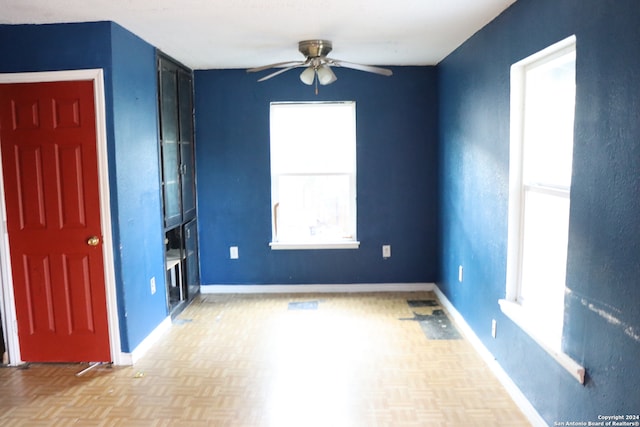 spare room with light parquet flooring and ceiling fan