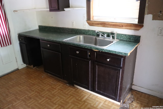 kitchen featuring sink and light parquet flooring