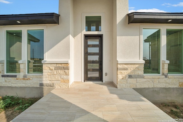 entrance to property with a patio