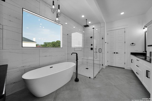 bathroom with vanity, plus walk in shower, and tile walls