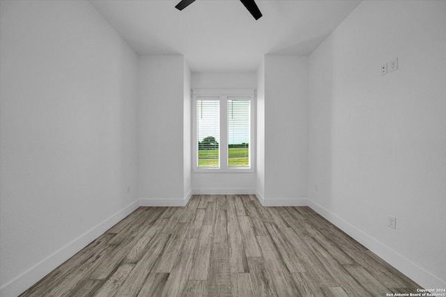 empty room with light hardwood / wood-style flooring and ceiling fan