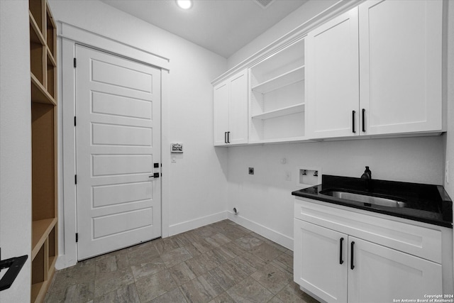 clothes washing area featuring hookup for an electric dryer, hookup for a washing machine, sink, and cabinets