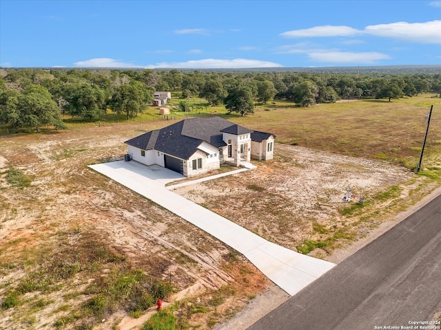 birds eye view of property with a rural view