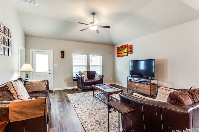 living room with ceiling fan, dark hardwood / wood-style floors, and vaulted ceiling