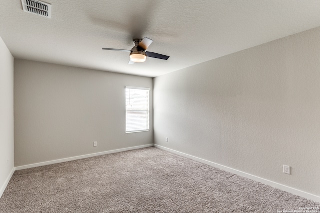 empty room with carpet flooring, a textured ceiling, and ceiling fan