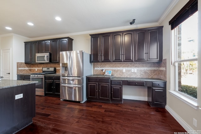 kitchen with crown molding, appliances with stainless steel finishes, and dark hardwood / wood-style floors