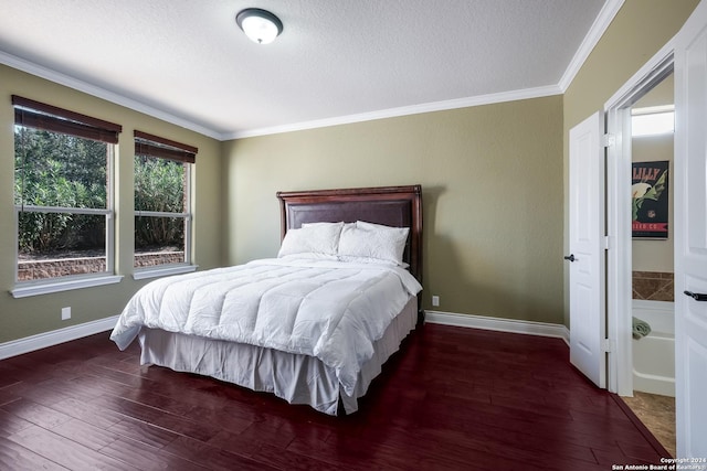 bedroom featuring wood finished floors, a textured ceiling, crown molding, and baseboards