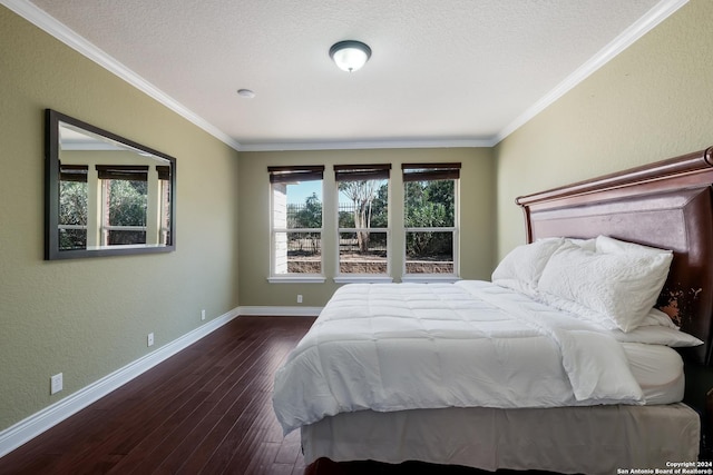 bedroom featuring hardwood / wood-style flooring, baseboards, and ornamental molding