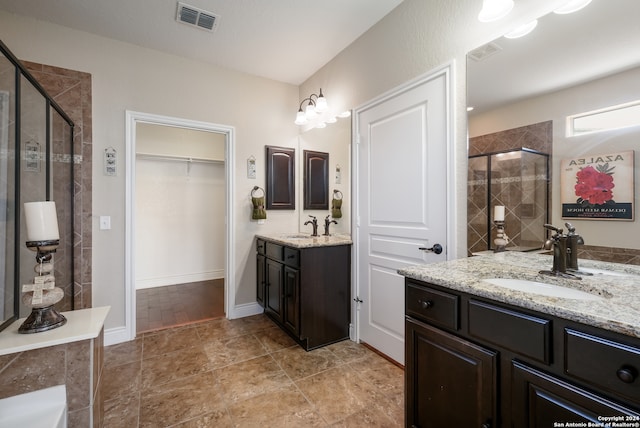 bathroom with vanity and a shower with shower door