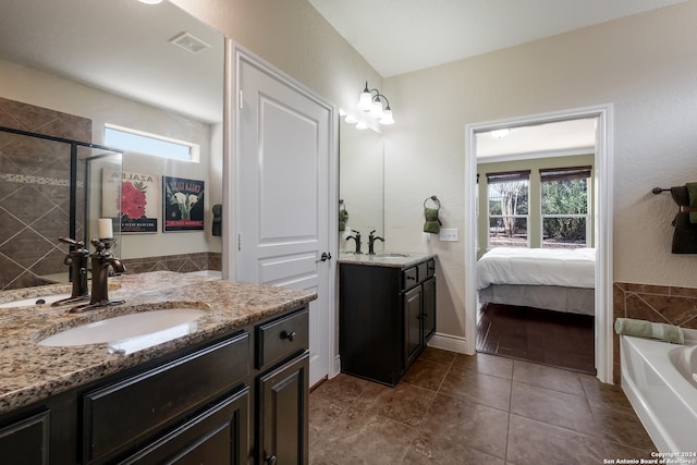 bathroom featuring vanity, shower with separate bathtub, and tile patterned floors