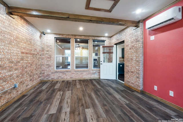 empty room featuring beamed ceiling, baseboards, an AC wall unit, and dark wood-style flooring